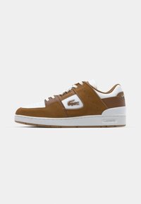 Brown suede and white leather sneaker with round toe, lace-up closure, side logo, and rubber sole. Notable color contrast and stitching details.