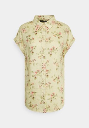 Kortærmet beige skjorte med knapper foran med pink og grøn blomsterprint og klassisk spids krave.