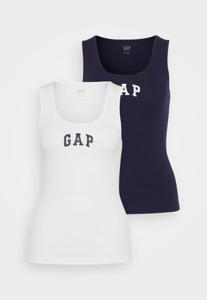 Two tank tops in white and navy, featuring a ribbed texture, scoop neck, and the word "GAP" printed in contrasting colors on the front.