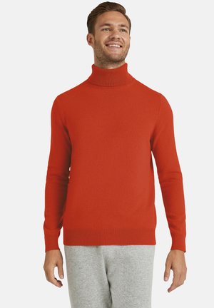 Rode coltrui gemaakt van zachte stof, met lange mouwen, geribbelde boorden en zoom, gedragen met grijze joggingbroeken.