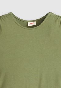 Olive green cotton t-shirt with a round neckline, gathered detail on sleeves, and a smooth texture. Label visible inside the collar.