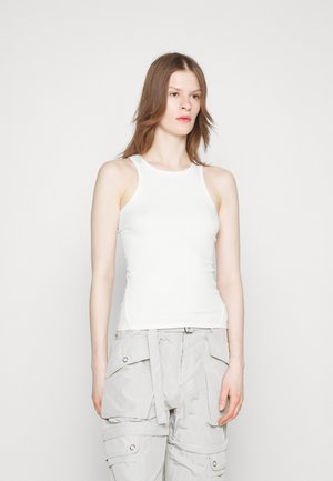 White ribbed tank top with a fitted design, featuring wide shoulder straps and a scoop neckline. The fabric has a smooth texture.