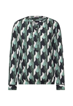 Langarmblouse in zwart, groen en wit geometrisch patroon; heeft een splitnek en een elastische onderrand voor een ontspannen pasvorm.