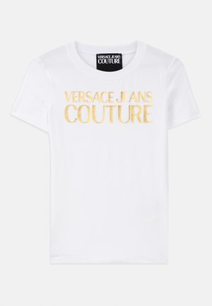 White cotton t-shirt featuring bold gold text reading "VERSACE JEANS COUTURE" on the front. Classic crew neck design, short sleeves.