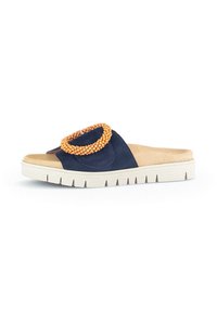 Navy blue slide sandal with a textured suede upper, accented by an orange beaded ring on the strap and a white, ridged sole.