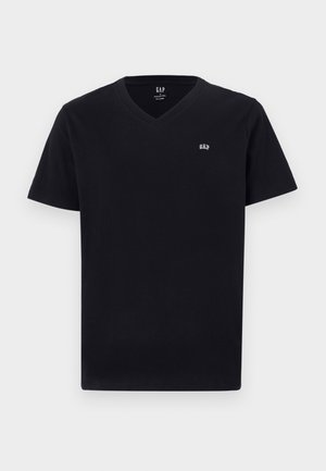 T-shirt en coton noir avec un col en V, des manches courtes et un petit logo brodé blanc sur la poitrine gauche. Texture lisse, coupe classique.