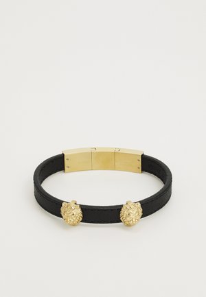 Schwarzes Lederarmband mit zwei goldenen Löwenkopfverschlüssen und einem glatten metallischen Verschluss, der eine runde Form und strukturiertes Material betont.