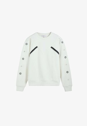 Sudadera blanca de manga larga con ribete en zigzag negro en el pecho y motivos de sol y círculos en ambas mangas.