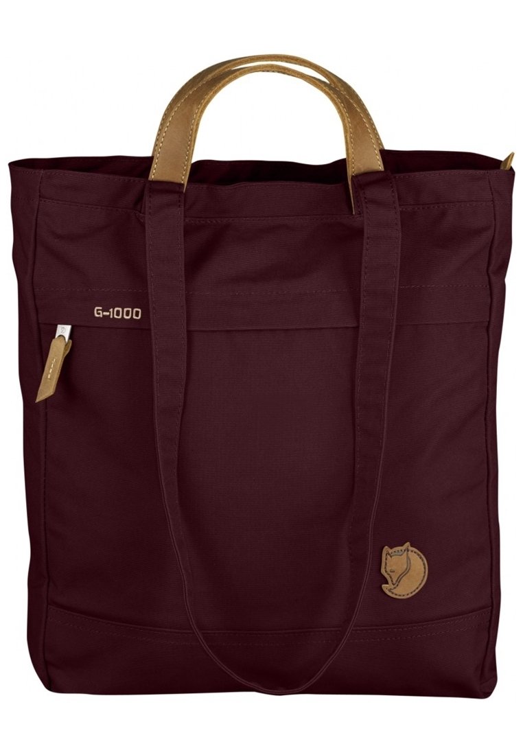 Sac fourre-tout en tissu marron avec des poignées et des accents en cuir beige, présentant un logo G-1000 et un emblème circulaire avec un motif de renard.
