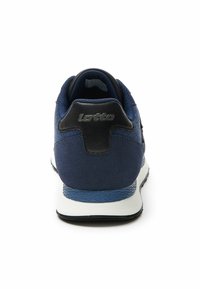 Navy blue athletic shoe featuring a textured fabric upper and a black leather heel accent, with a white midsole and patterned outsole.