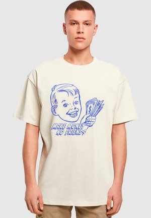 Cream-colored cotton t-shirt featuring a blue graphic of a cartoon boy holding cash with the text "MAKE MONEY NO FRIENDS" below.