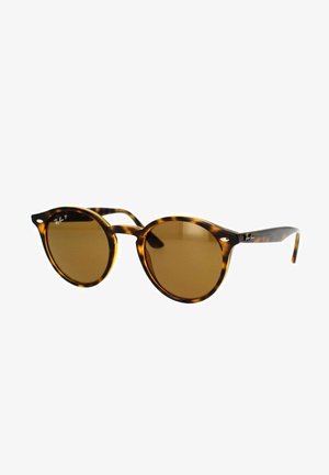 Gafas de sol de carey con lentes redondos y tinte marrón. Presenta acentos metálicos en la montura. Material plástico ligero.