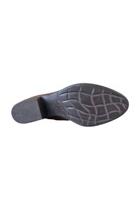 Diepbruine schoenen onderkant met getextureerd rubber en een geometrisch profiel. Platte hak met een lichte verhoging aan de achterkant.