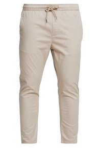 Beige, lichte broek met een elastische tailleband, taps toelopende pijpen en zijzakken. Glad van textuur, geschikt voor casual draag.