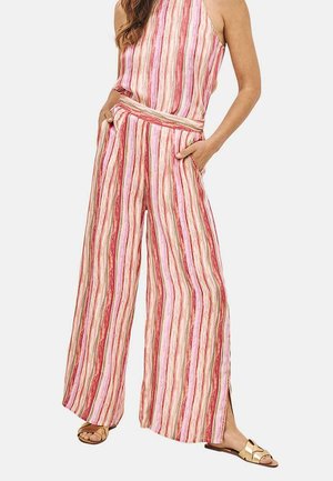 Mono a rayas con líneas verticales en rosa, rojo y marrón. Piernas anchas de corte holgado, cuello halter y bolsillos laterales. Tejido ligero.