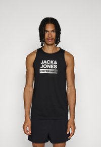 Camiseta sin mangas negra con un gran logo impreso en blanco "JACK & JONES PERFORMANCE" en el frente. Confeccionada con una tela suave y ligera.