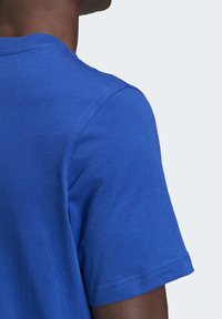 Royal blue cotton t-shirt with a round neck, short sleeves, and a soft texture. Visible stitching along the shoulder and hem.