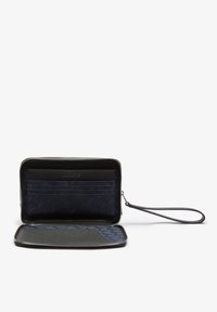 Zip-around wallet in dark navy fabric with leather accents. Features multiple card slots, a zippered compartment, and a detachable wrist strap.