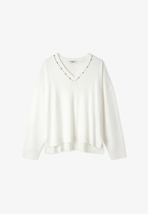 Biały sweter dzianinowy z dekoltem w kształcie litery V i ozdobnymi ćwiekami wzdłuż dekoltu. Posiada długie rękawy i lekko skrócony dół. Teksturowana tkanina.
