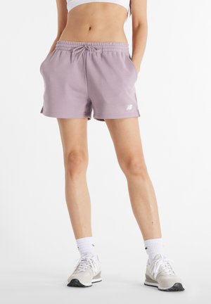 Pantalones cortos deportivos en color lila con cintura elástica, cordón de ajuste y bolsillos laterales. Presenta un pequeño logo blanco en el dobladillo izquierdo.