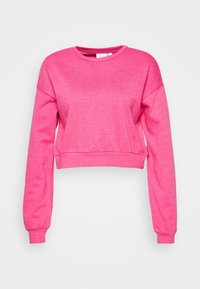 Růžová zkrácená mikina vyrobená z měkké a lehké tkaniny. Má dlouhé rukávy, kulatý výstřih a žebrované manžety a lem.