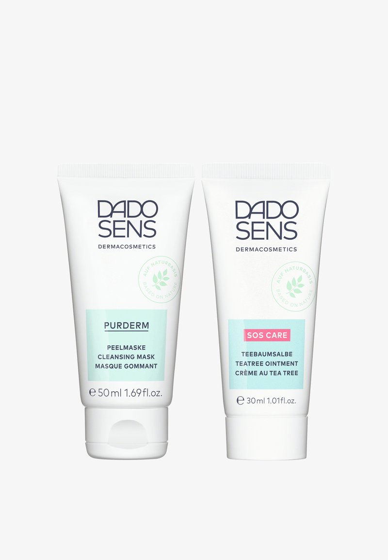 Two white tubes of DADO SENS dermacosmetics: left is PURDERM cleansing mask (50 ml), right is SOS CARE tea tree ointment (30 ml).