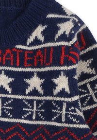 Pull en tricot avec une base bleu marine, orné d'étoiles blanches et de texte rouge. Le design comprend des motifs géométriques et un col côtelé.