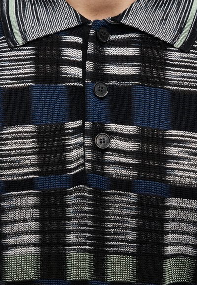 Knitted polo shirt featuring a plaid pattern in black, blue, and white, with black buttons and a striped collar in grey and mint green.