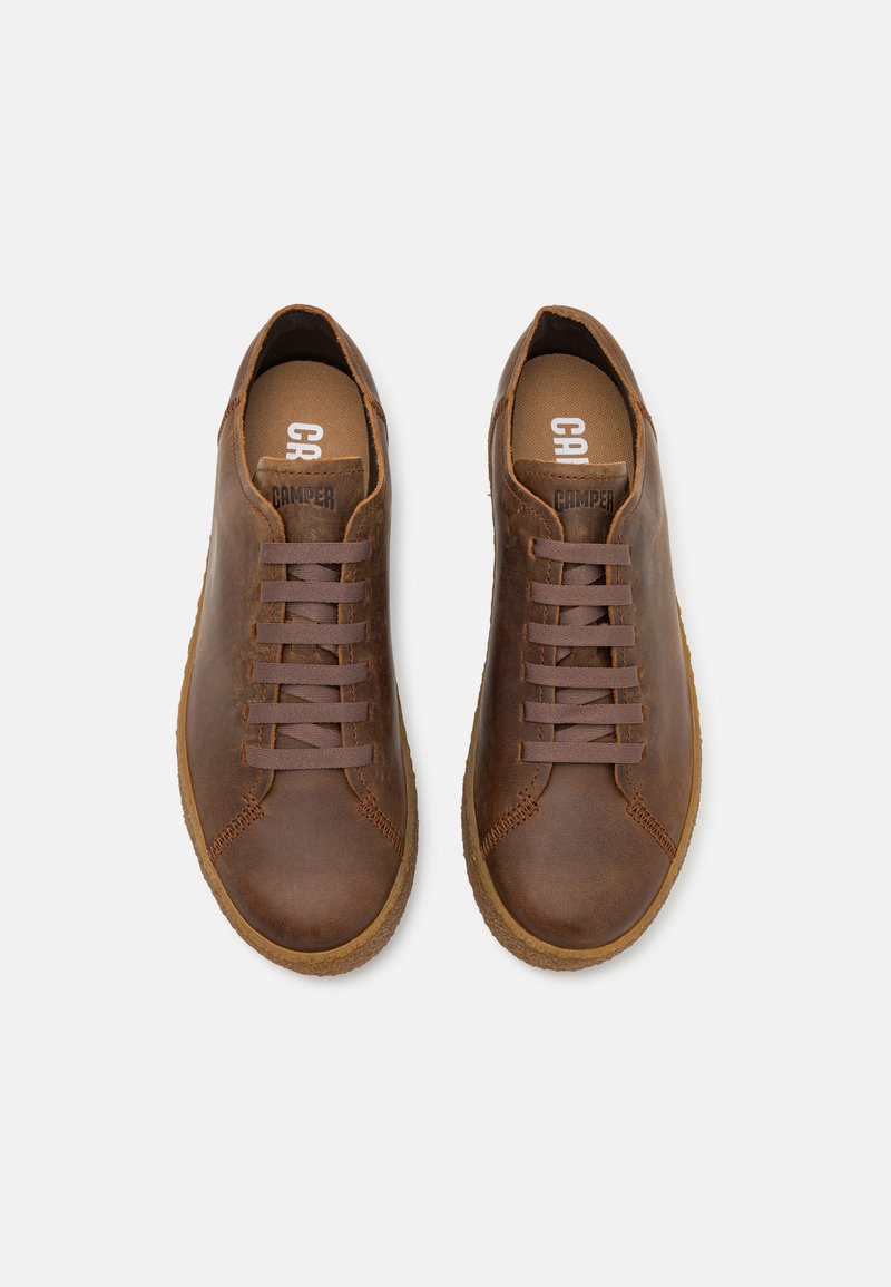 Brown leather sneakers with round toe, gray laces, and durable rubber sole. Includes "CAMPPER" logo on the insole. Texture appears smooth.