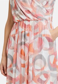 Leichtes Kleid mit überlappenden kreisförmigen Mustern in Rosa-, Grau- und Orangetönen, mit gestraffter Taille und seitlichen Taschen.