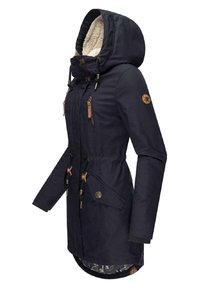 Navy blue parka coat with a faux fur-lined hood, drawstring waist, multiple pockets, and brown accents. Smooth outer fabric, mid-length design.