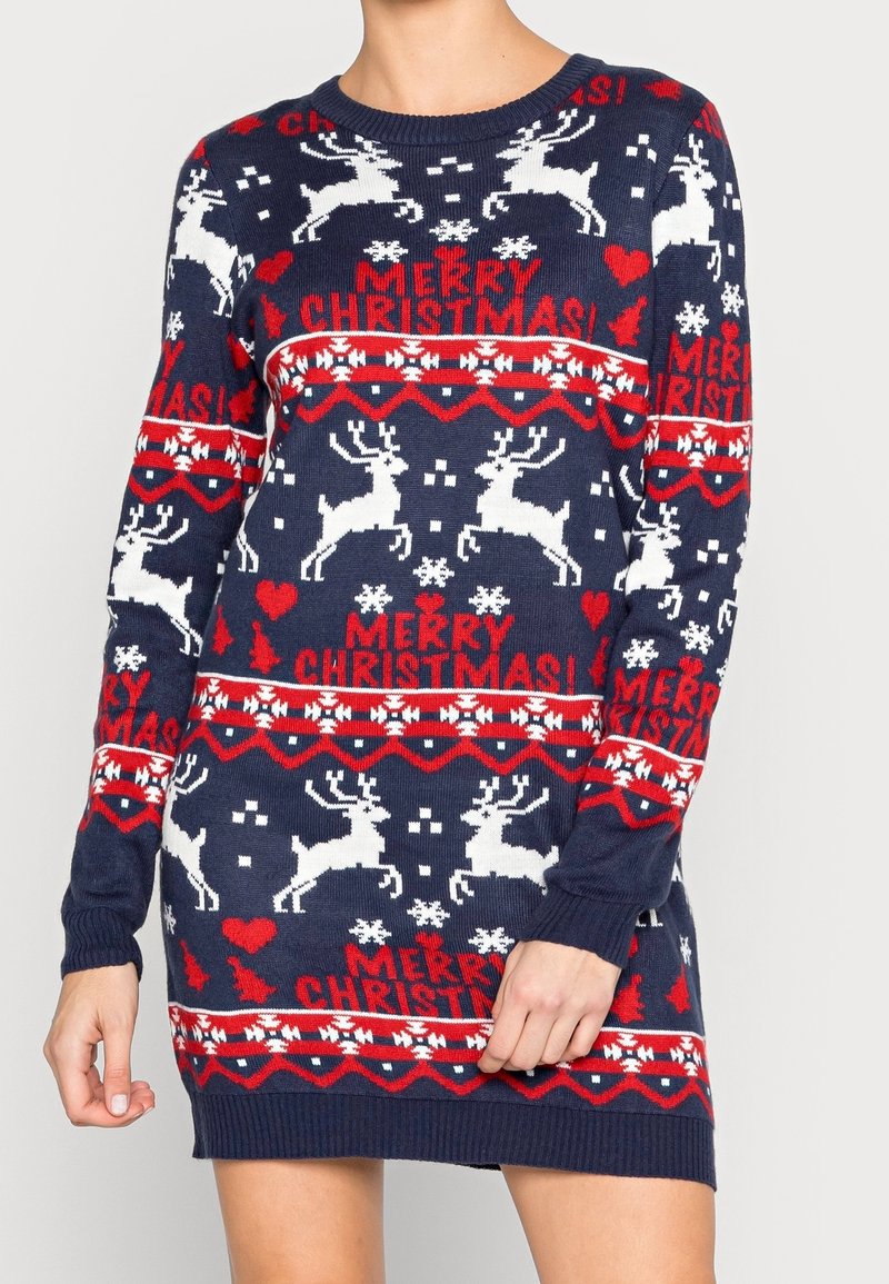 Robe pull de Noël bleu marine avec des rennes blancs, des cœurs rouges, des flocons de neige, des sapins de Noël et le texte « Joyeux Noël ! » en rouge.