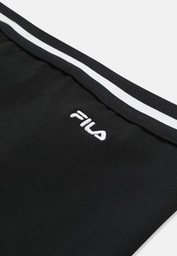 Musta kangas, jossa valkoinen FILA-logo, joka on kirjailtu mustan joustovyötärön alapuolelle. Vyötärössä on yksi valkoinen raita.