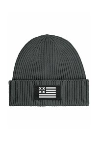 Grey knitted beanie with a ribbed texture and a fold-over cuff, featuring a black patch with a white flag design.