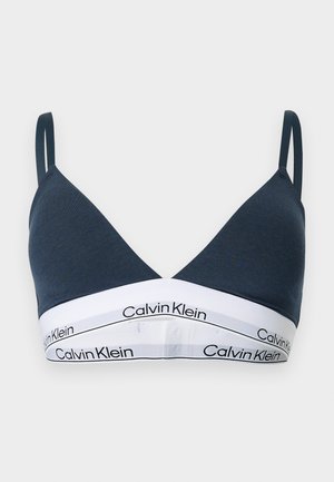 Tumesinine kolmnurkse lõikega bralet õhukeste rihmade ja valge elastse paelaga, millel kordub musta värvi Calvin Kleini logo.