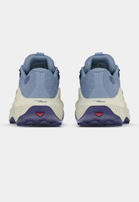 Αθλητικά παπούτσια ανοιχτού μπλε χρώματος με υφασμάτινη υφή, χοντρή κρεμ σόλα και σκούρες μοβ λεπτομέρειες. Διαθέτουν θηλιά για εύκολο φόρεμα και συγκεκριμένη τεχνολογία απορρόφησης κραδασμών.