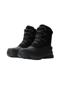Bottes noires imperméables avec un design à la cheville haute, tissu texturé, bout renforcé et lacets ajustables. Semelle en caoutchouc épaisse avec traction.