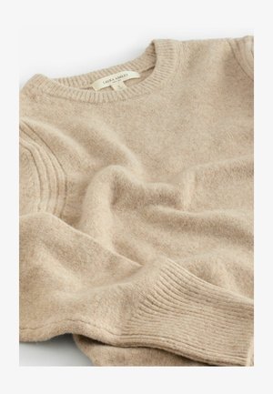 Pull en laine mélangée beige tricoté, avec un col rond, des poignets côtelés et des détails sur les côtés avec une texture légèrement pelucheuse.