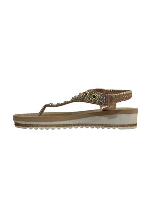 Women's wedge sandal with beige sole, metallic rose gold straps, elastic ankle band, and decorative gems on the thong strap.