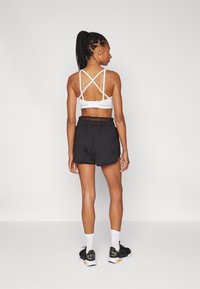 Puma PAMELA REIF SHORTS - Sporta šorti - black