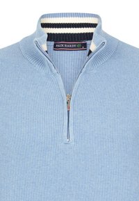 Light blue knit pullover with a high collar, zip closure, and ribbed detailing. Features a striped accent of navy and white at the collar.