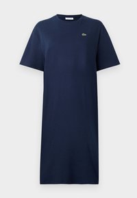 Navy blue cotton t-shirt dress with short sleeves, crew neck, and a small green logo on the chest. Straight cut, knee-length design.