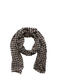 Sciarpa lavorata a maglia con pattern a pied de poule in nero e beige, con bordi sfilacciati e una trama morbida. Forma circolare, drappeggiata in modo casuale.