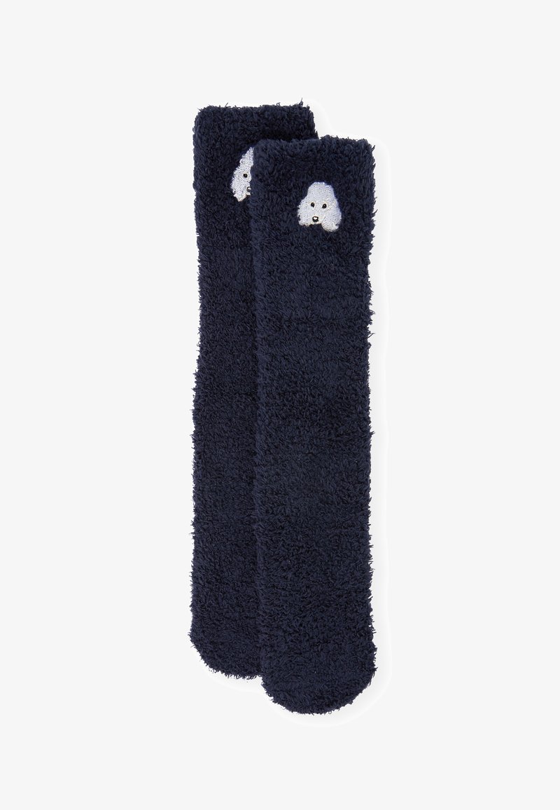 Calzini soffici di colore blu navy con una texture morbida, caratterizzati da una testa di cane bianca ricamata sul risvolto.