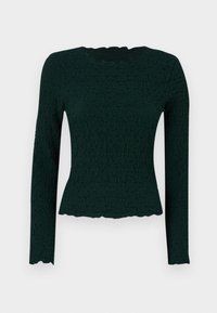 Dark green long-sleeve top featuring a textured fabric with a wavy hemline and a rounded neckline. Slim fit with a stretchable material.