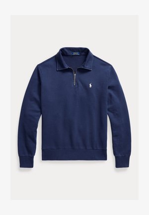 Tumši zils garroku džemperis ar pusjostiņas apkakli, ribotām aprocēm un mazu baltu Polo Ralph Lauren logo uz krūtīm.
