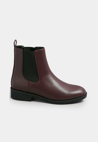 Bottines Chelsea en cuir bordeaux avec des panneaux latéraux en élastique et une languette à l'arrière ; texture lisse et petit talon empilé. Semelle extérieure en caoutchouc noir.