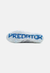 Cleated soccer shoe with a white and grey upper, featuring textured design, translucent outsole, and blue "PREDATOR" branding.