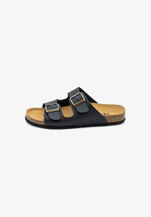Black sandal featuring two adjustable straps with gold-tone buckles, cork footbed, and rubber outsole. Smooth leather-like texture.