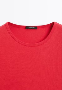 Red crew neck t-shirt with visible stitching around the collar and a black Massimo Dutti label inside the neckline.